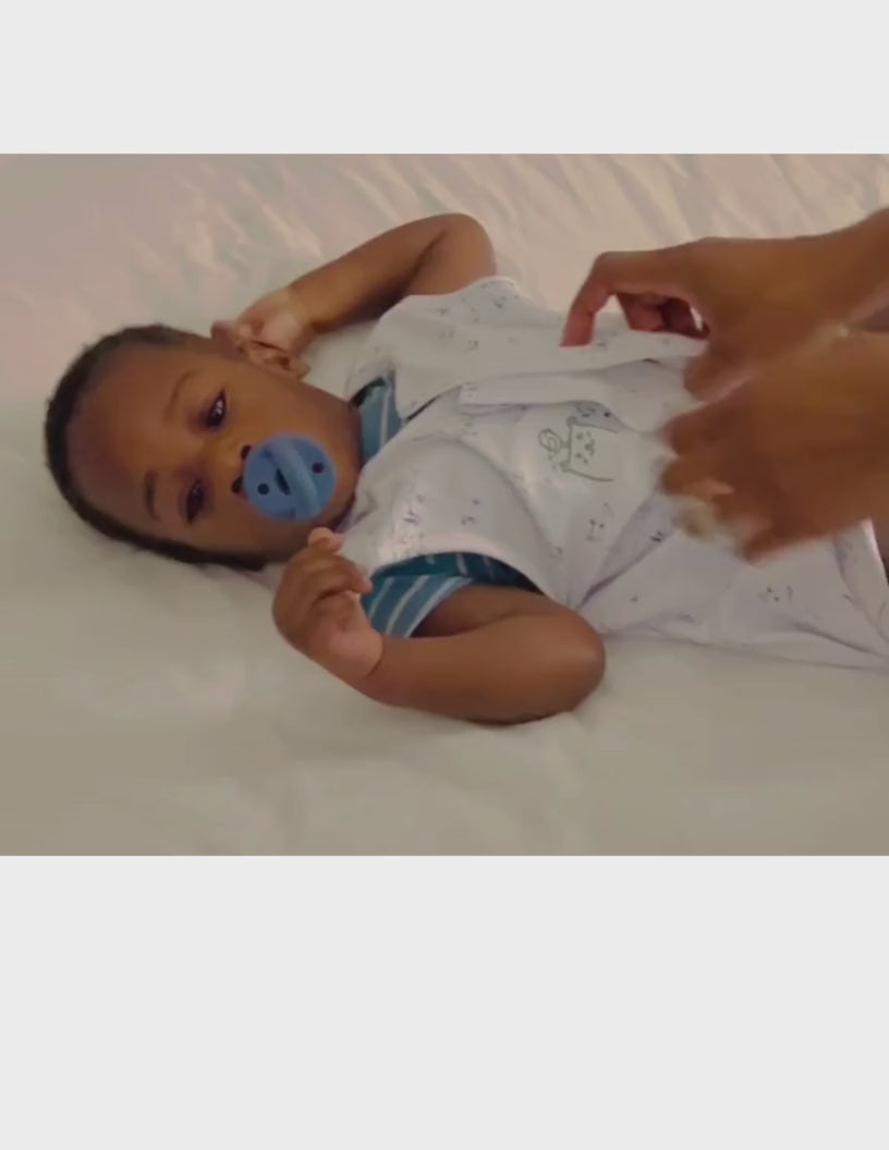 Load video: Getting baby ready to sleep in a sleep sack
